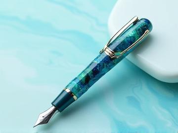'Aquatic Dream' fountain pen, with swirling blue and green resin, marked with a prominent 'SOLD' banner.