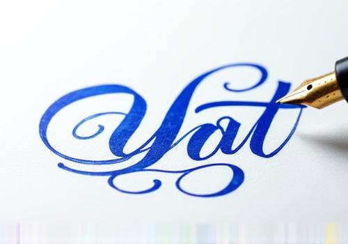 Artistic flourishes and decorative swirls written with a wet noodle nib, demonstrating extreme flexibility and control, using vibrant sapphire blue ink.