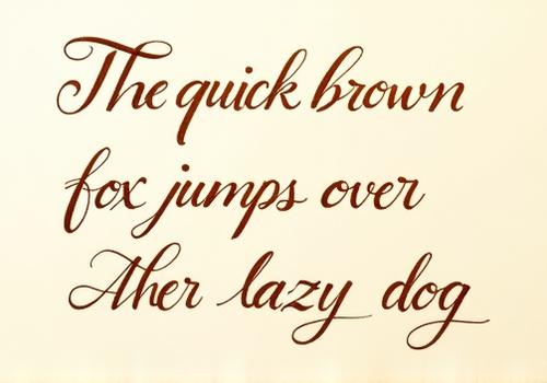 A pangram, 'The quick brown fox jumps over the lazy dog,' beautifully written with a wet noodle nib in rich sepia ink, highlighting continuous flex and shading.